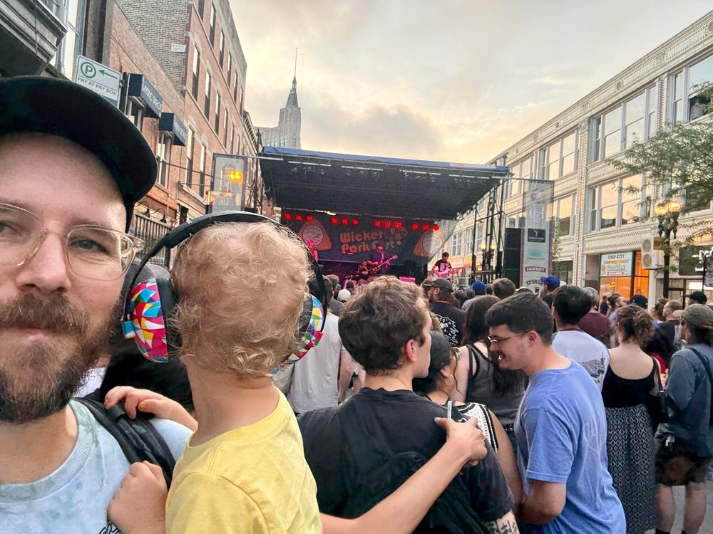 Selfie of me holding J with Liquid Mike playing on a stage at Wicker Park Fest.