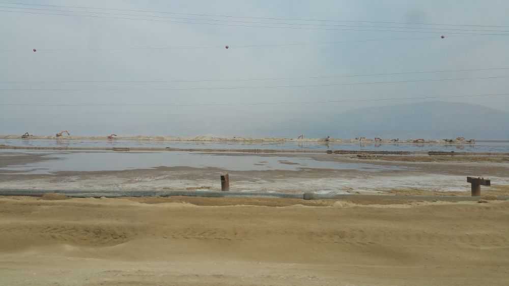 The Dead Sea being scooped up by over a dozen massive earth movers
