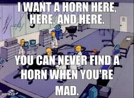 Still image from The Simpsons Season 2 episode "Oh Brother, Where Art Thou?" - Homer's in the design area of his brother's car factory talking to the boffins. The text over the image says "I WANT A HORN HERE, HERE AND HERE. YOU CAN NEVER FIND A HORN WHEN YOU'RE MAD."