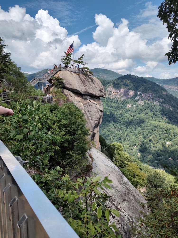 At eye level with the tip of Chimney Rock, side profile where you really see the chodeness. Has an American flag at the top