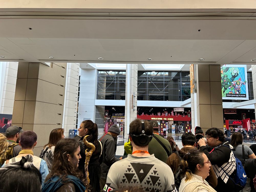 picture of the entrance to c2e2. there is a large audience waiting in the foreground.