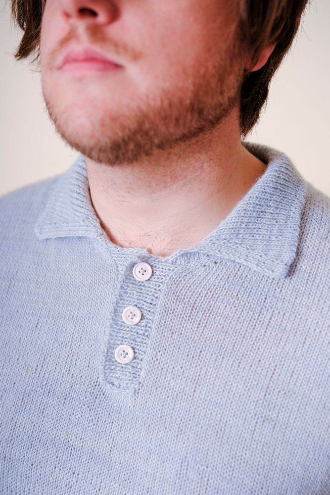 Close up of a blue polo button placket