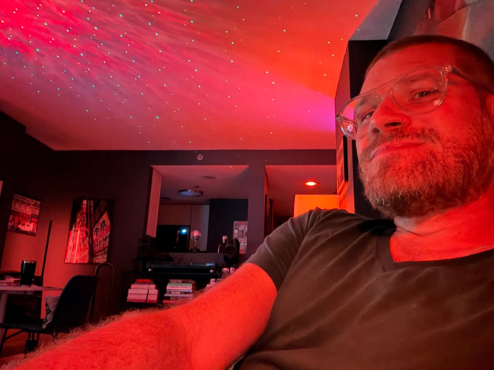 Me sitting in living room in orange light 