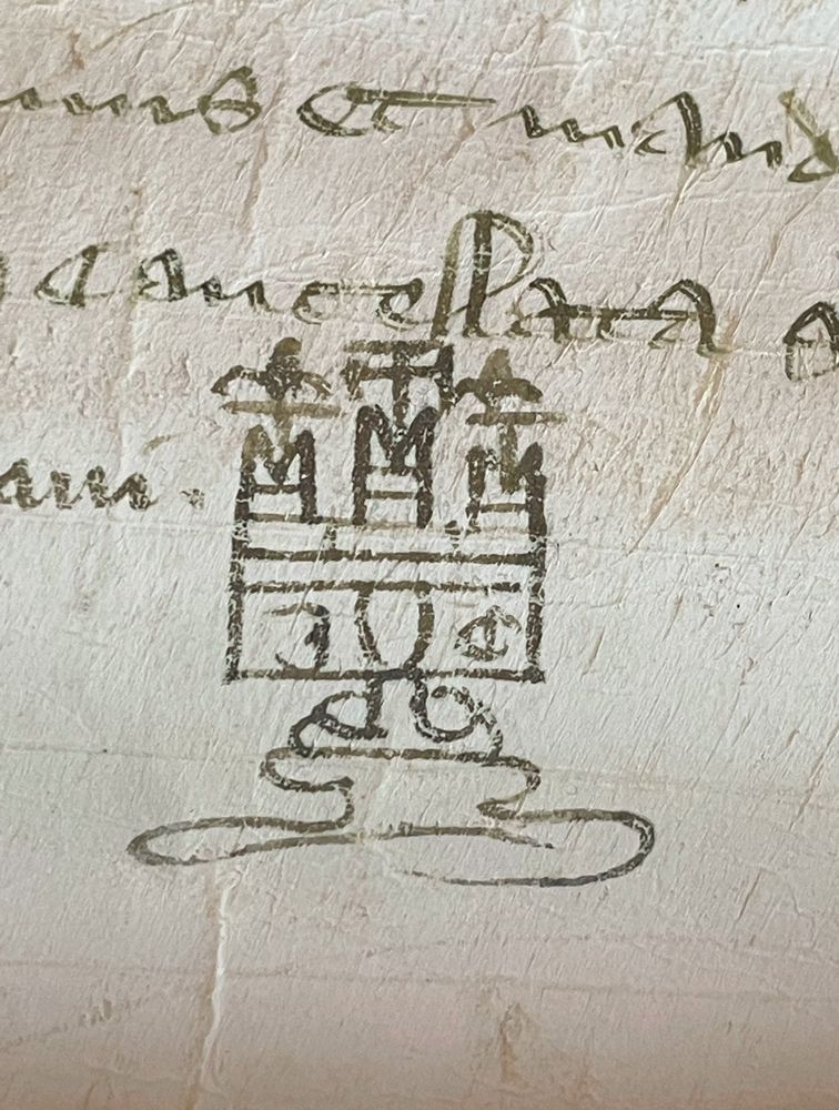 A 14th-century parchment manuscript with a doodle of a castle at the bottom. The Latin document is written in crabbed notarial hand.