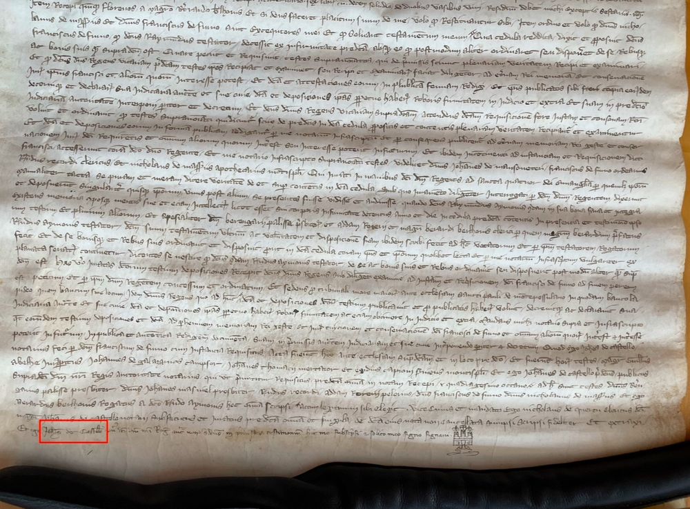 A 14th-century parchment manuscript with a doodle of a castle at the bottom. The Latin document is written in crabbed notarial hand.