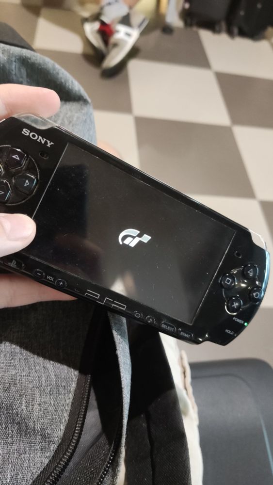 My PSP playing GT PSP in an airport