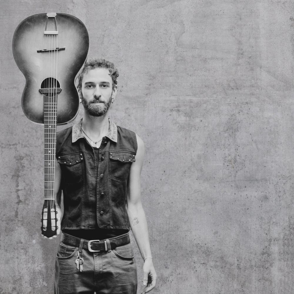 Kai Carter holding guitar