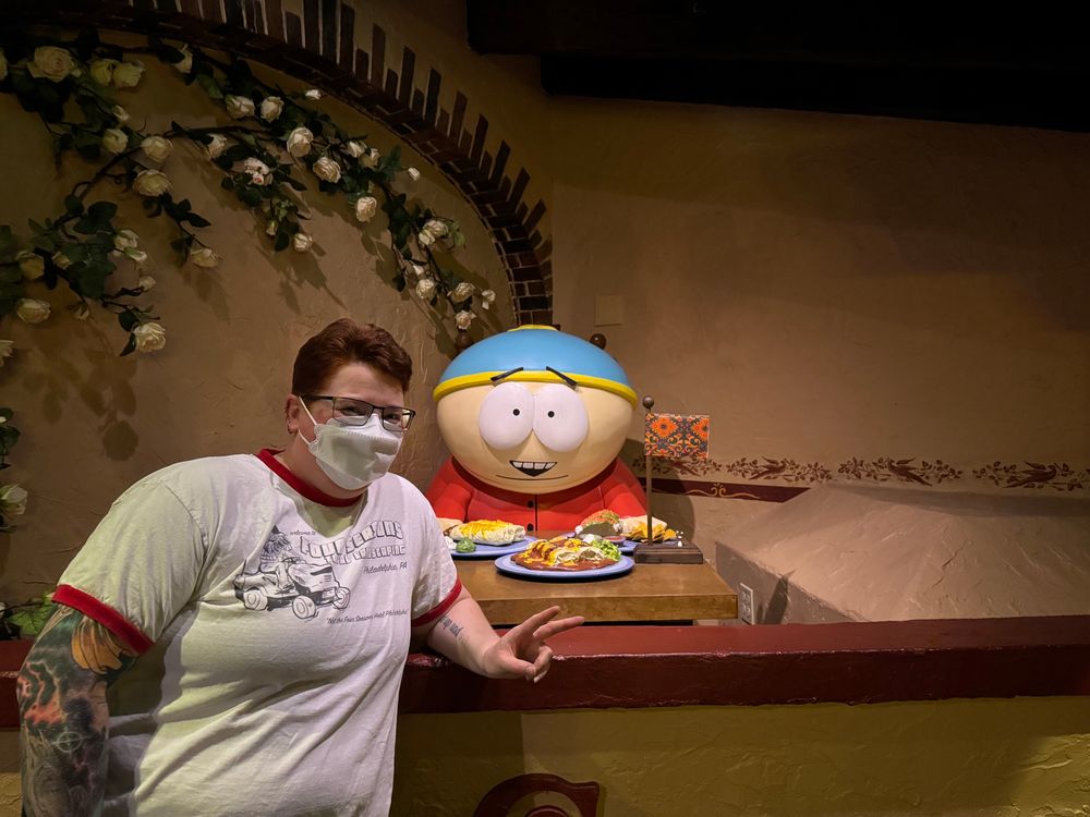 Me, wearing a mask, standing by Cartman and his collection of delightful Mexican food. Cartman is not wearing a mask.