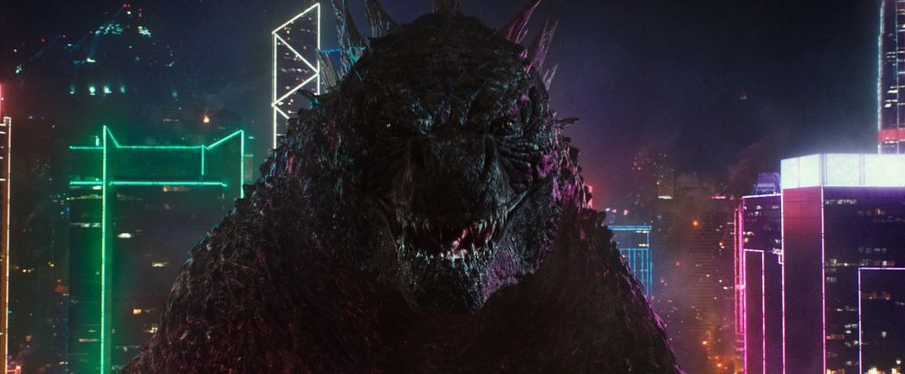 Monsterverse Godzilla smiling menacingly after hitting Kong in the back with his atomic breath.