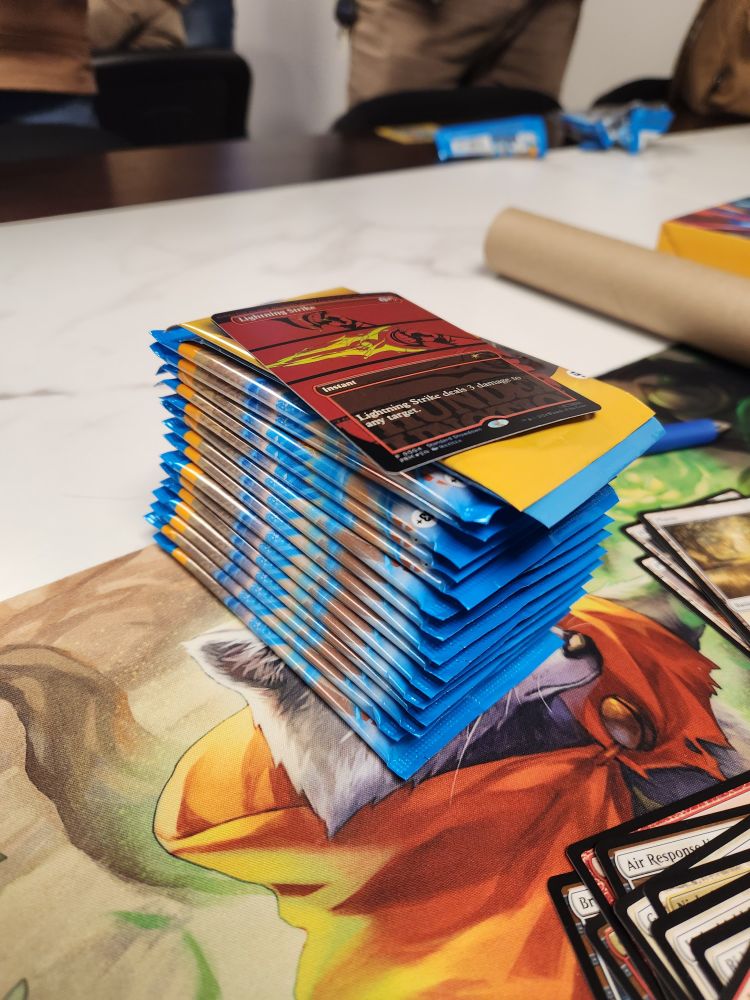 A stack of Aether Drift booster packs