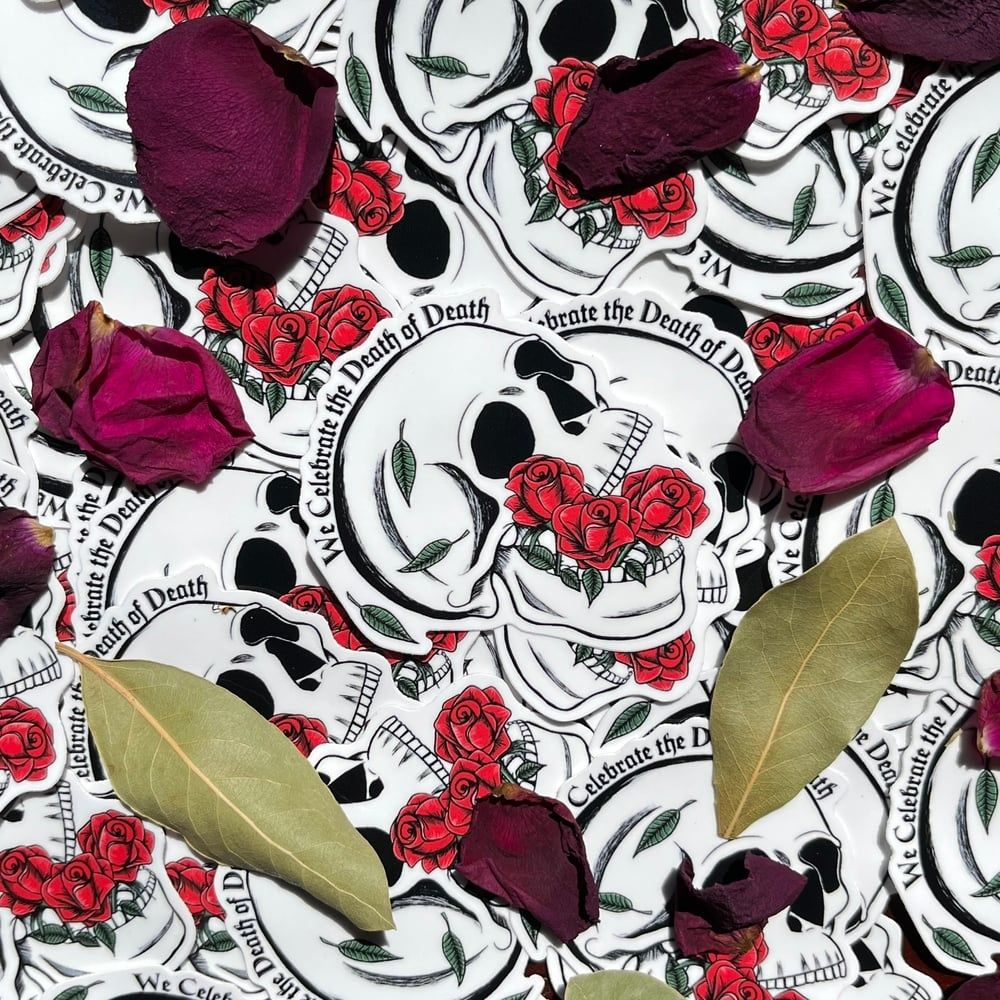 a sticker of a skull with roses in it's mouth. it says "we celebrate the death of death"