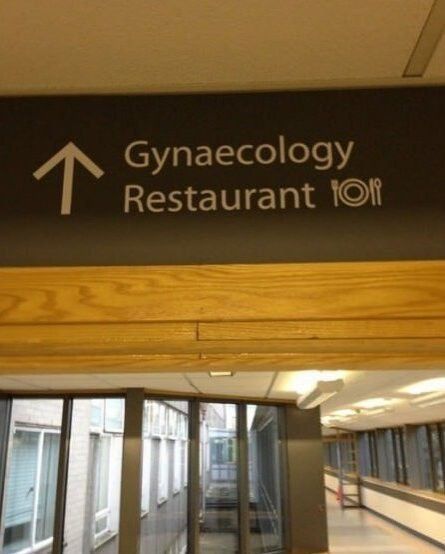 a sign with the words "Gynaecology" and "Restaurant" listed in the same direction