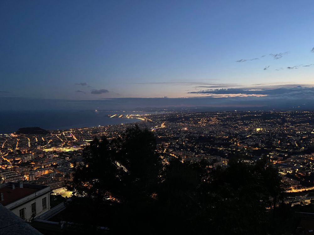 View of Nice by night, with many city lights below and still some sunset colours in the sky. Taken from Nice observatory, near the big dome (not visible)