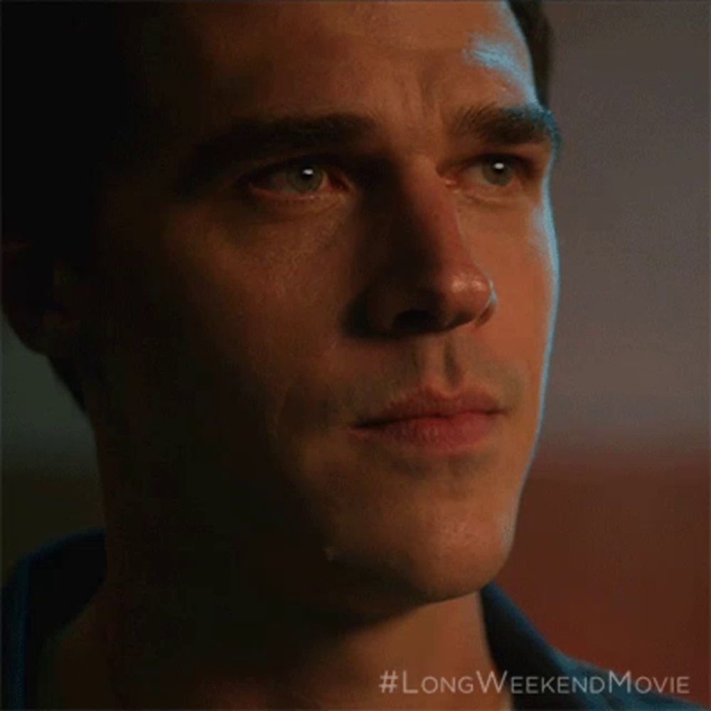 a close up of a man 's face with #longweekendmovie written on the bottom right