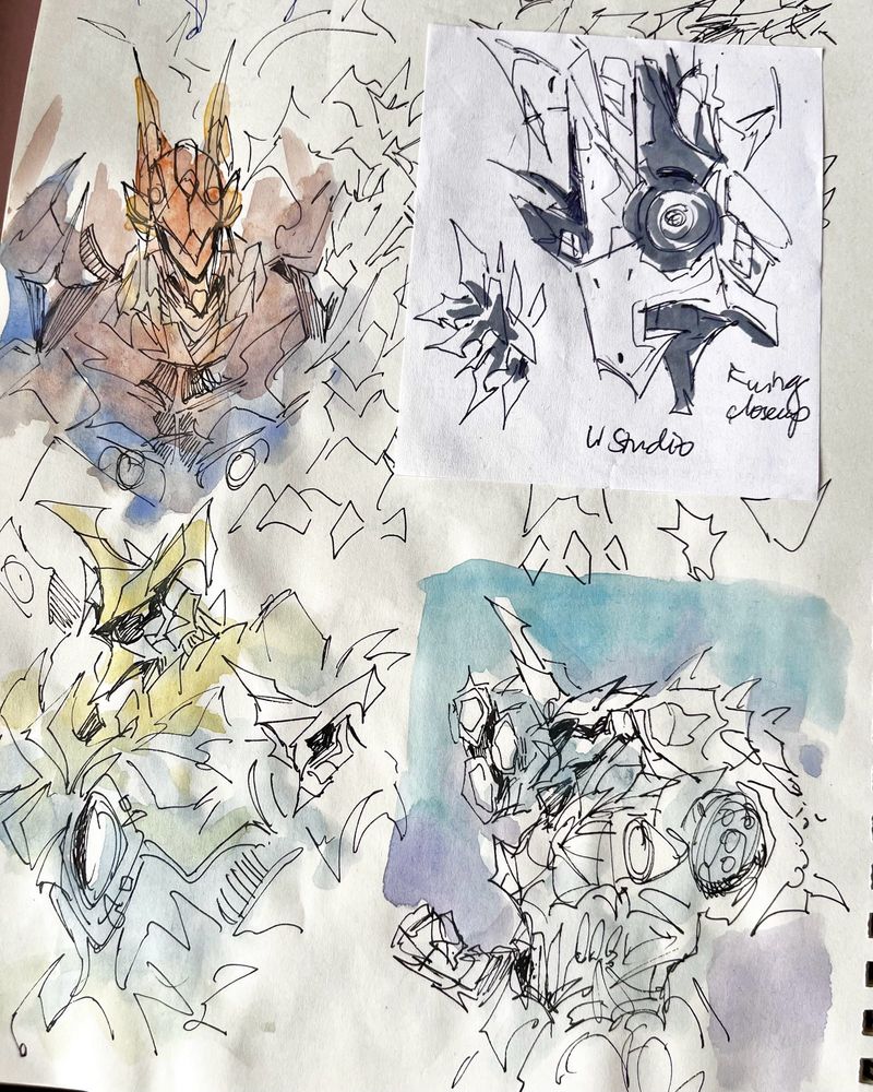 Ink and watercolor sketches of mecha busts along with a marker study of a mecha wing drawn on the back of a train ticket receipt