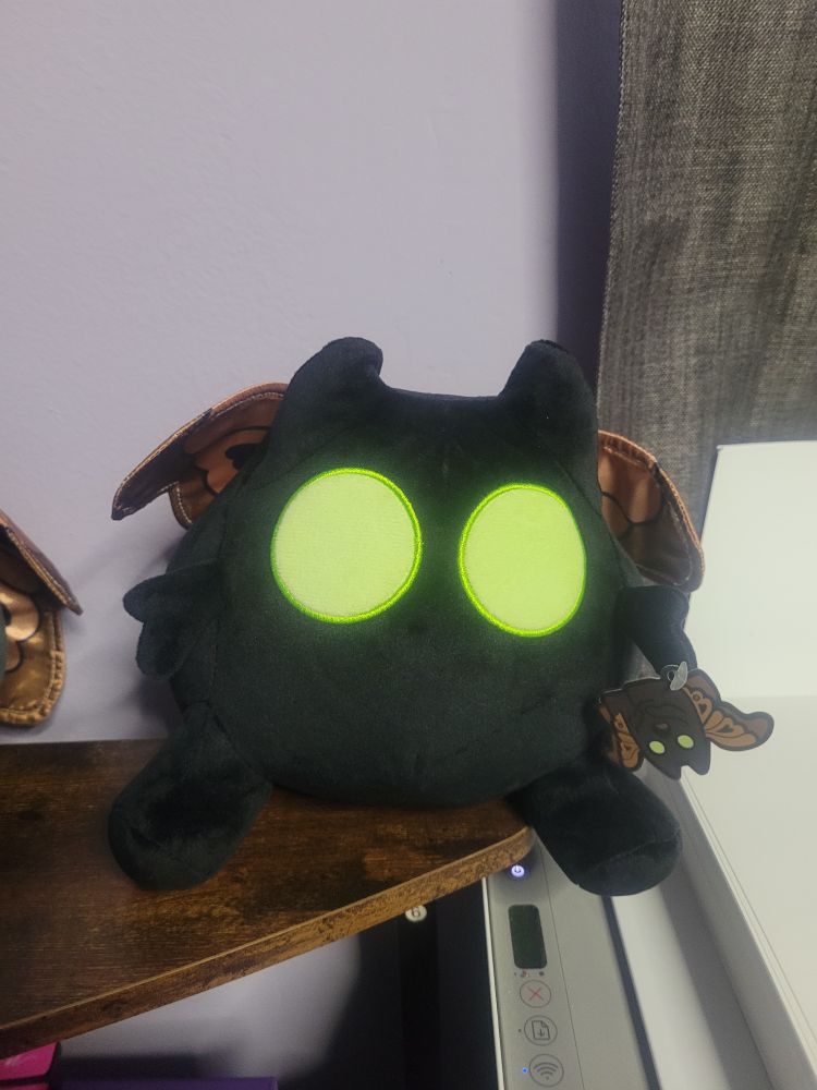 The Chilluminati podcast green-eyed variant of the Moffmin plush.