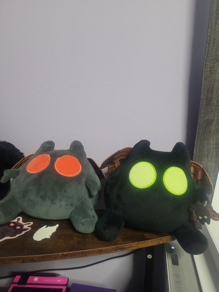 Both the Chilluminati original red-eyed Moffmin plush and variant green-eyed Moffmin plush.