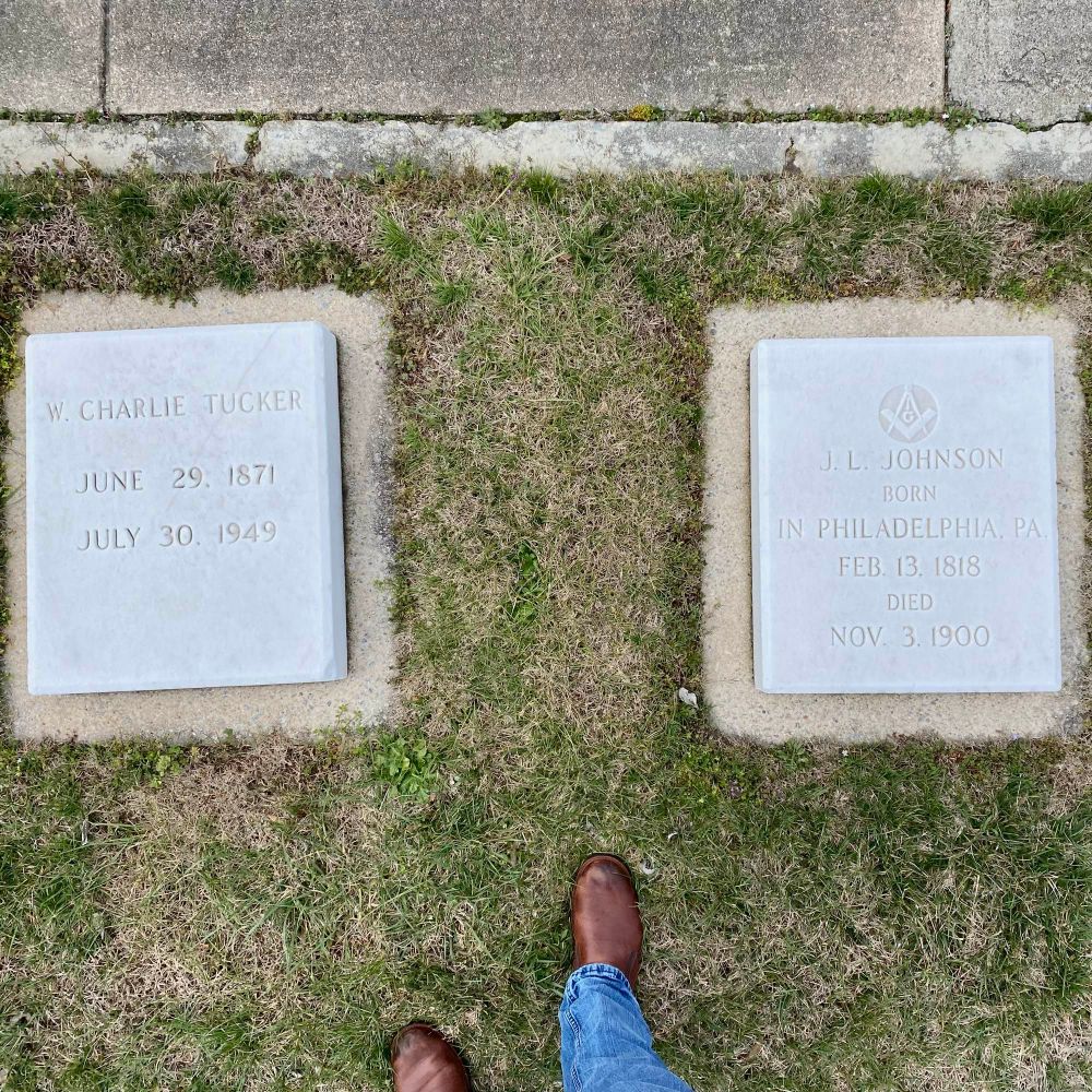 Photo of two recumbent white marble headstones in a Moravian cemetery.