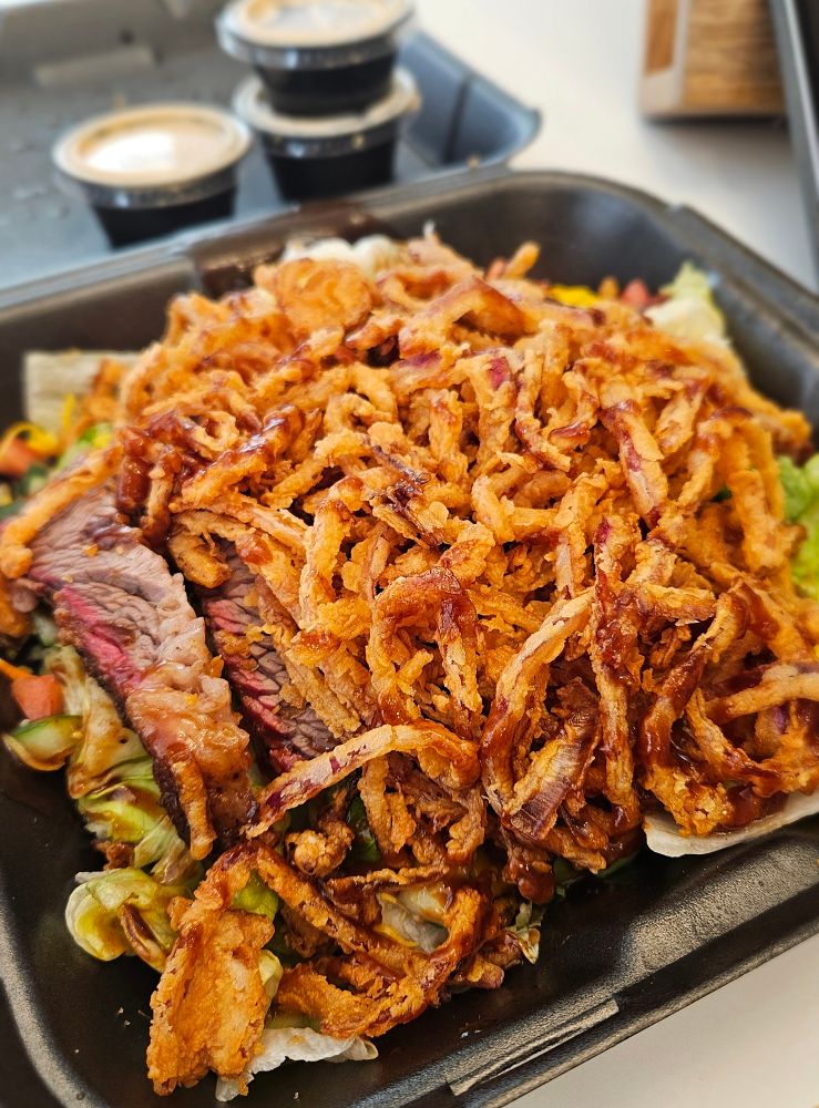 BBQ salad from Sonny's BBQ featuring a lot of crispy onion straws on the top