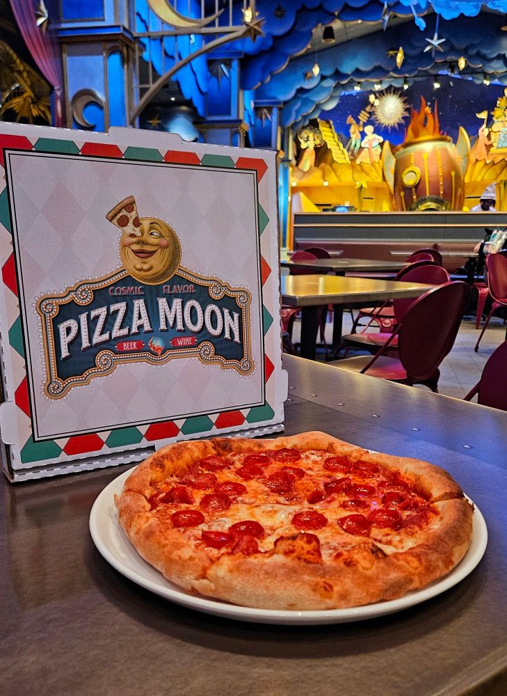 A pepperoni pizza and pizza box at Pizza Moon at Universal Epic Universe 