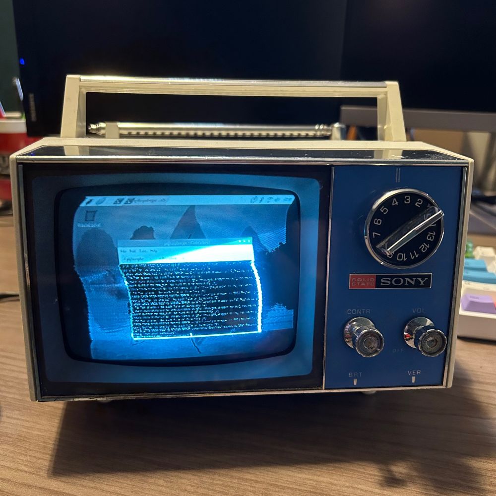 Picture of an old 5” black and white crt tv displaying a raspberry pi’s desktop and terminal window. 