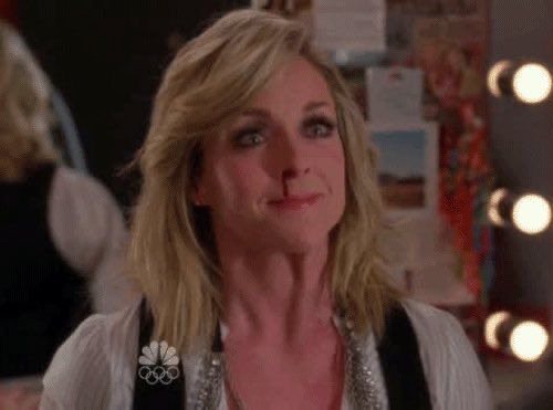 Jane Krakowski as Jenna Maroney on 30 Rock doing a 1000 yard stare with a bloody nose