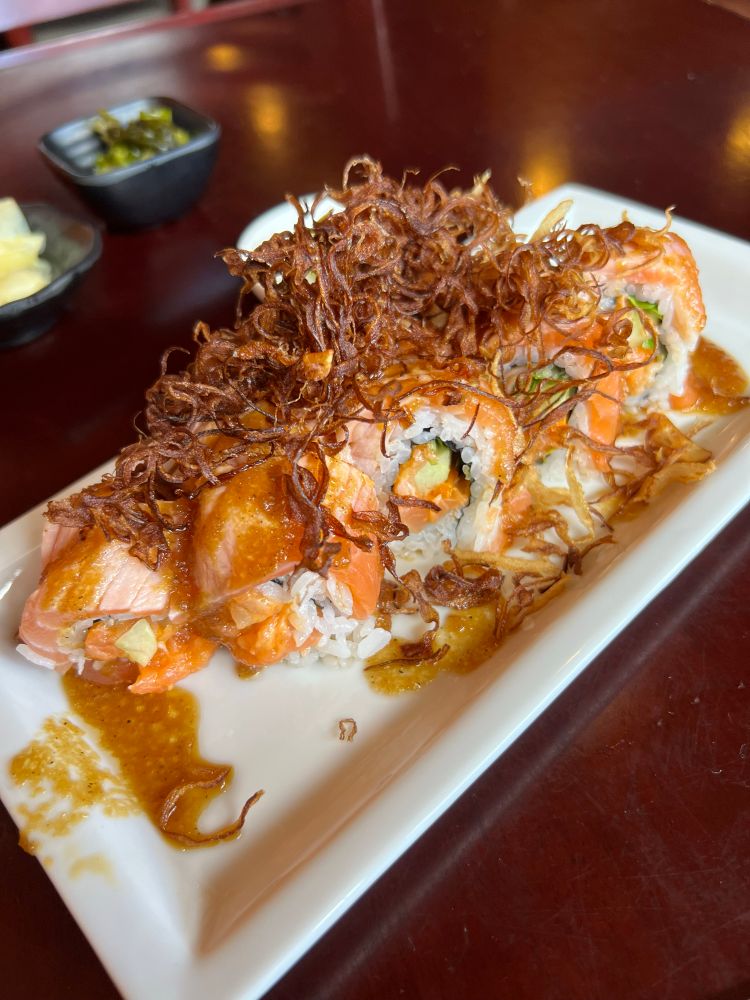 Double salmon sushi roll topped with fried onions