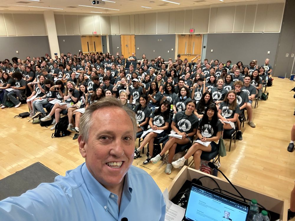 Elderly reporter takes selfie in front of hundreds of high school students at WJMC