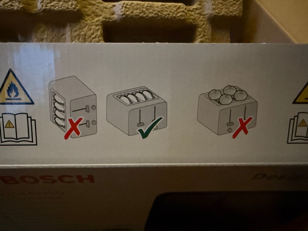 Instructional diagram from toaster packaging: sideways toast, no; upright toast, yes; balancing buns on top of toaster, no. 