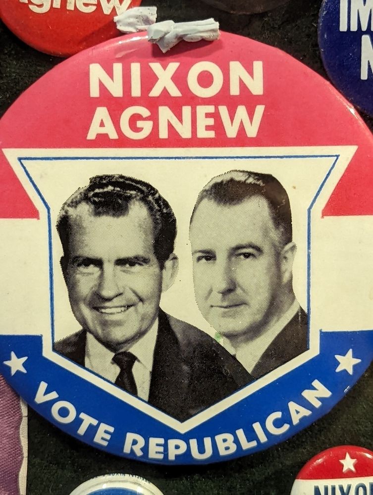 A political campaign button features the text Nixon Agnew and Vote Republican along with black-and-white portraits of the two men.