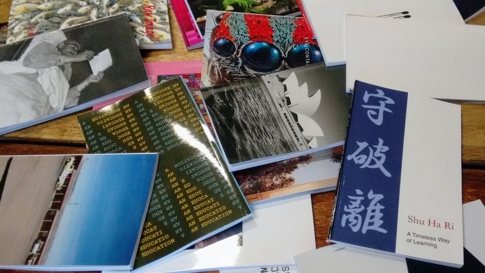 A A collection of various colorful books and cards scattered on a wooden surface.