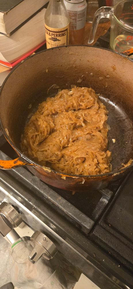 Onions in an orange pot looking brown and jammy!!