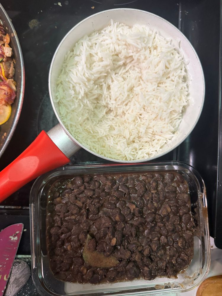 A pot of white rice and a dish of black beans