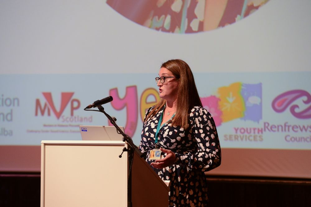 Nicola Sykes from Education Scotland stands at a podium talking.