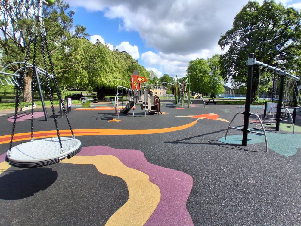 A play park with swings, chutes and climbing frames.