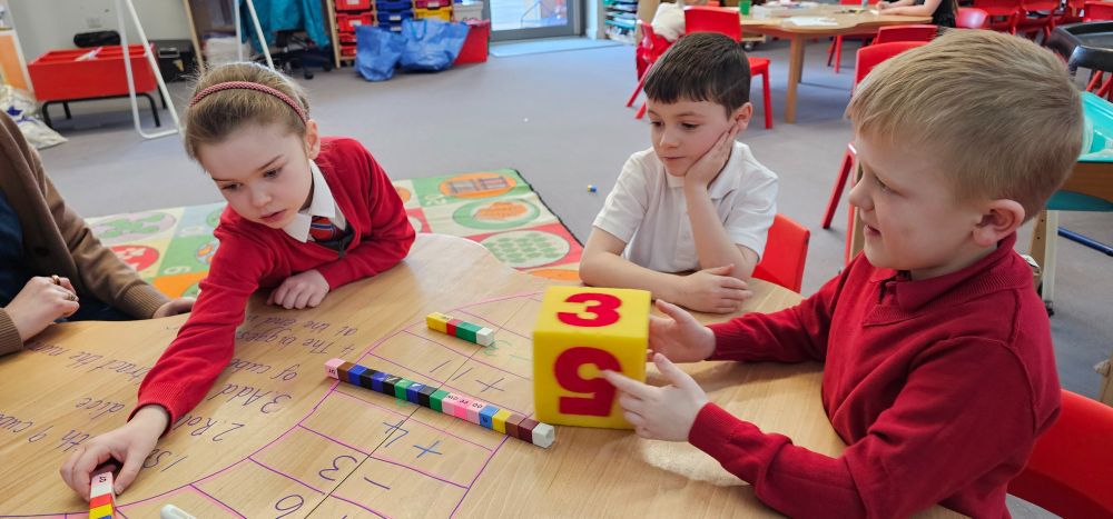 Three pupils play a maths game.