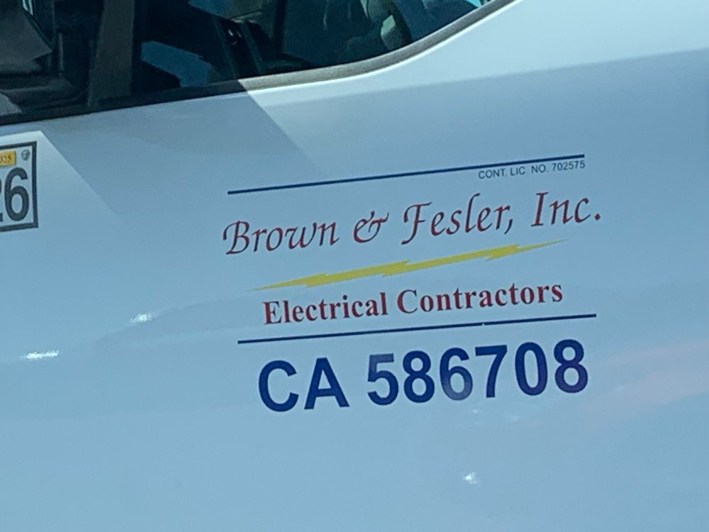 Side of a heavy-duty pickup truck with an electrical business’s information displayed on a white background-it reads: Brown & Fester, Inc. Electrical Contractors CA 586708