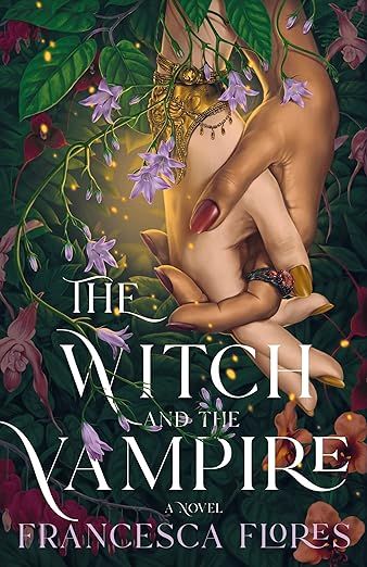 The cover of THE WTICH AND THE VAMPIRE, featuring two clasped hands surrounded by flowers