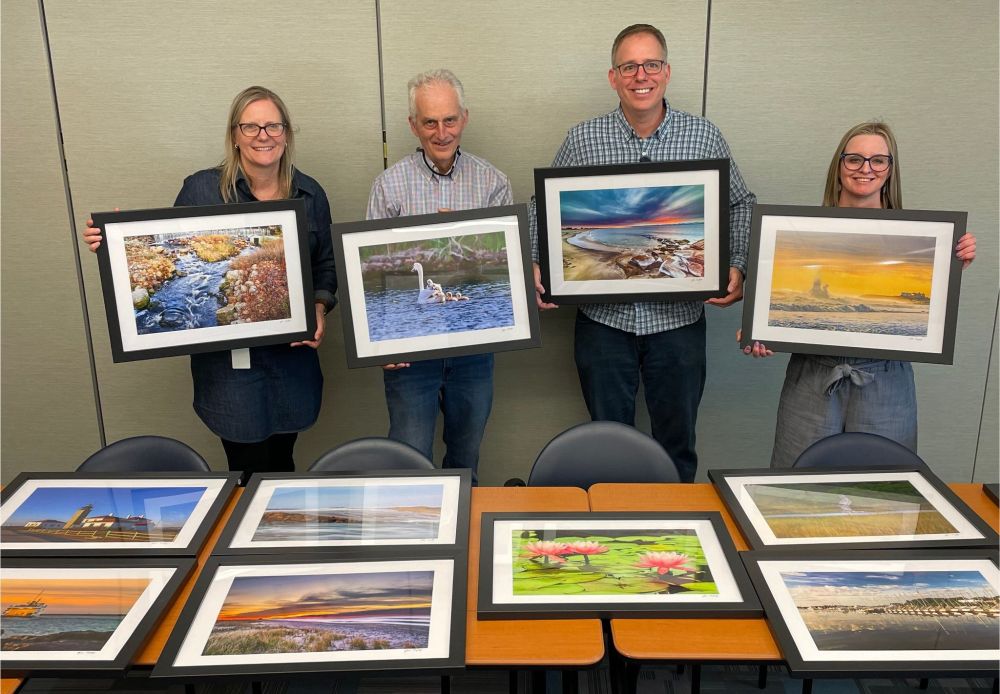 John, second from left, with Thundermist staff holding four of the 19 framed photographs he donated for our South County exam rooms.