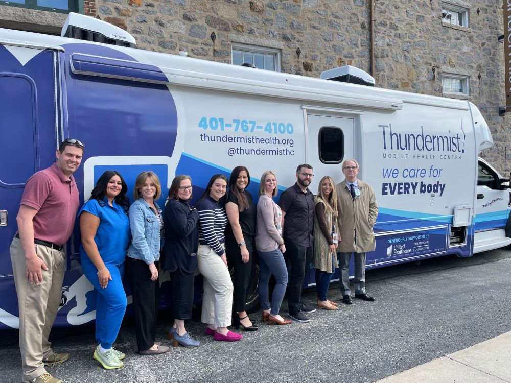 Group shot of some of United Healthcare staff and Thundermist employees in front of the unit outside our West Warwick health center.