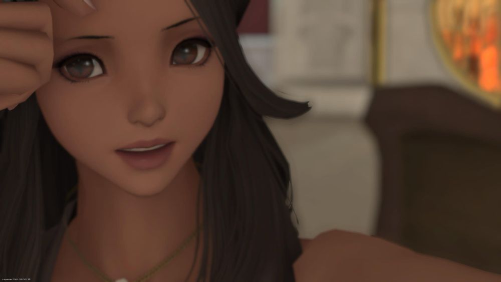 Vye touching her hair looking into the camera