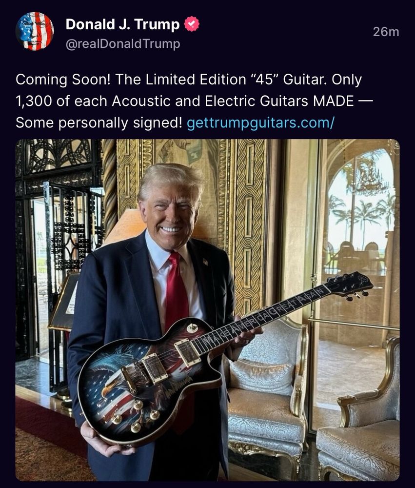 Trump holding up his dumb Les Paul copy that no actual musician will ever actually buy and play. 