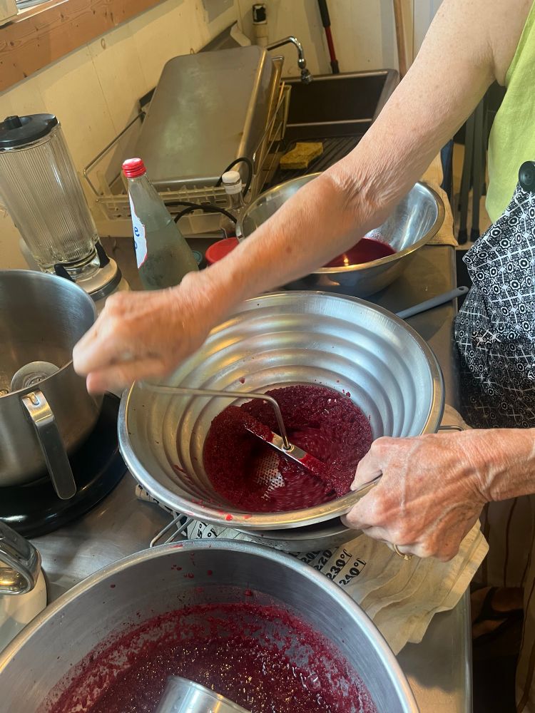 A fruit mill grinding up cherry paste 