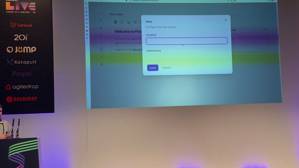 Photo of Dan introducing filament v4 at Laravel live uk. Blocks open up modal window