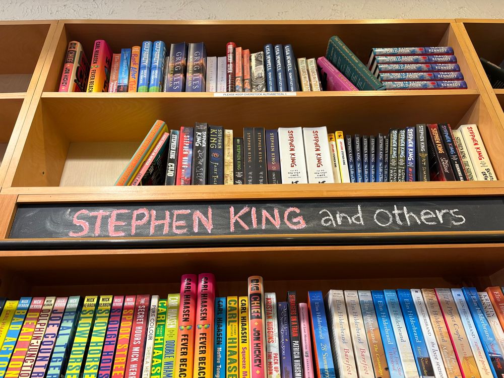 Picture of a bookstore when a shelf titled, “Stephen King and others”