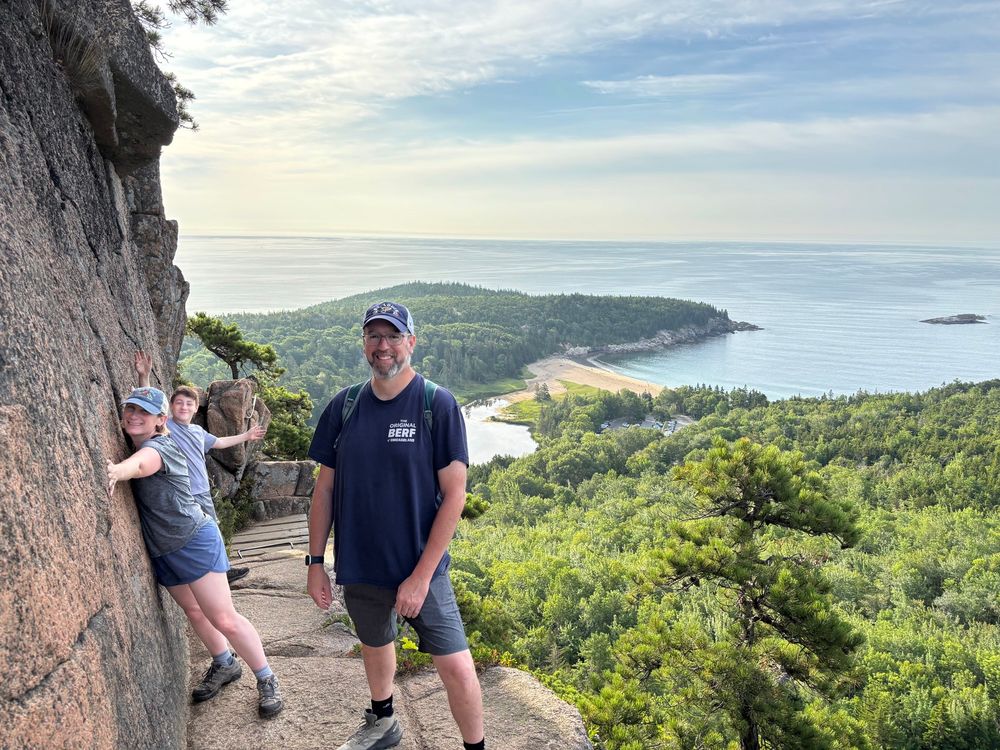 Me, on the Beehive hike, with my wife clinging to the stone cliff and my son tempting fate