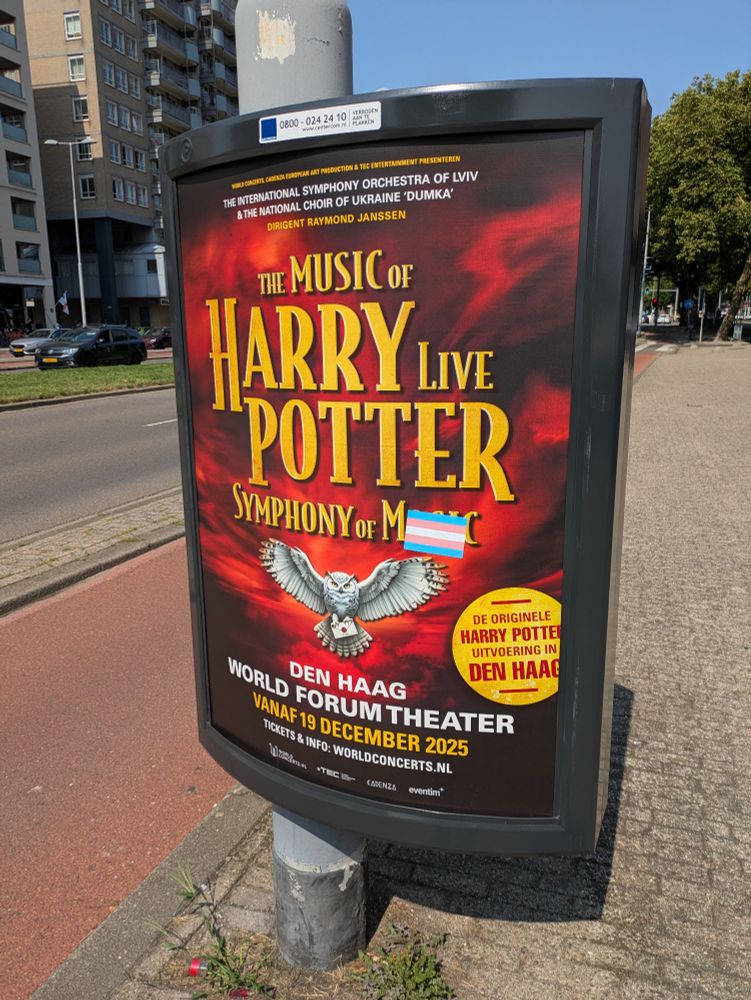 "The Music Of Harry live Potter"
"Symphony of ??? (Magic?)"

A big trans flag sticker is slapped over the last word

"Symphony of Trans Pride"