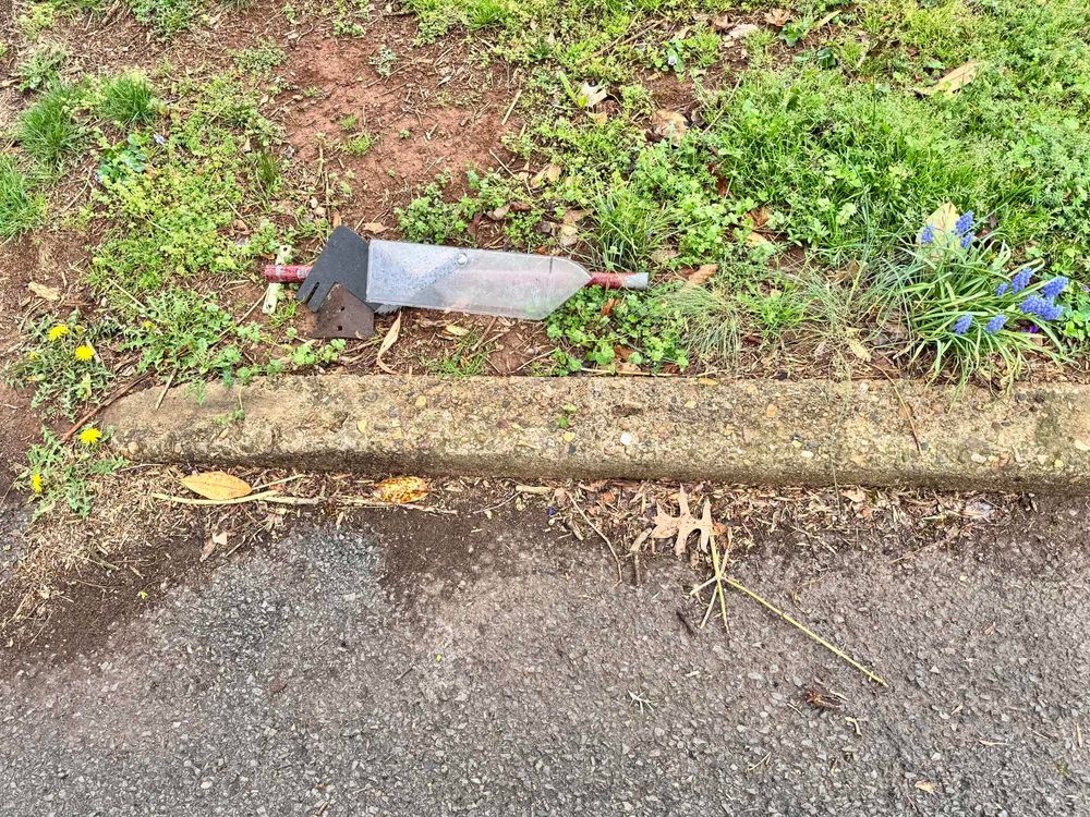Plastic table saw safety guard discarded by the side of a street