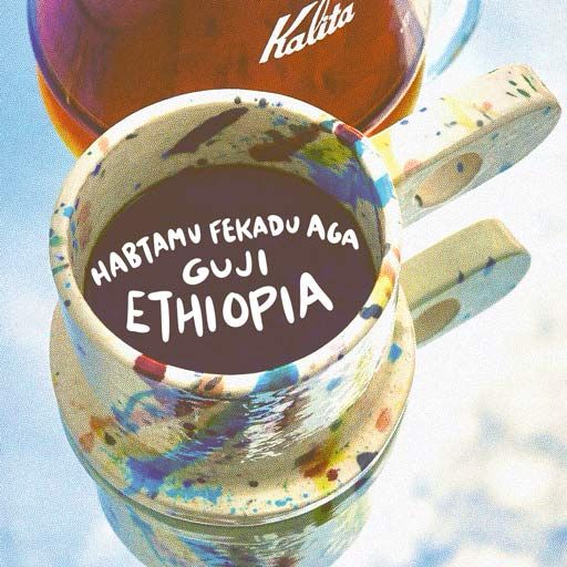 A colorful mug of coffee sits atop a mirror. Habtamu Fekadu Aga, a washed coffee from the Guji zone of Ethiopia. 