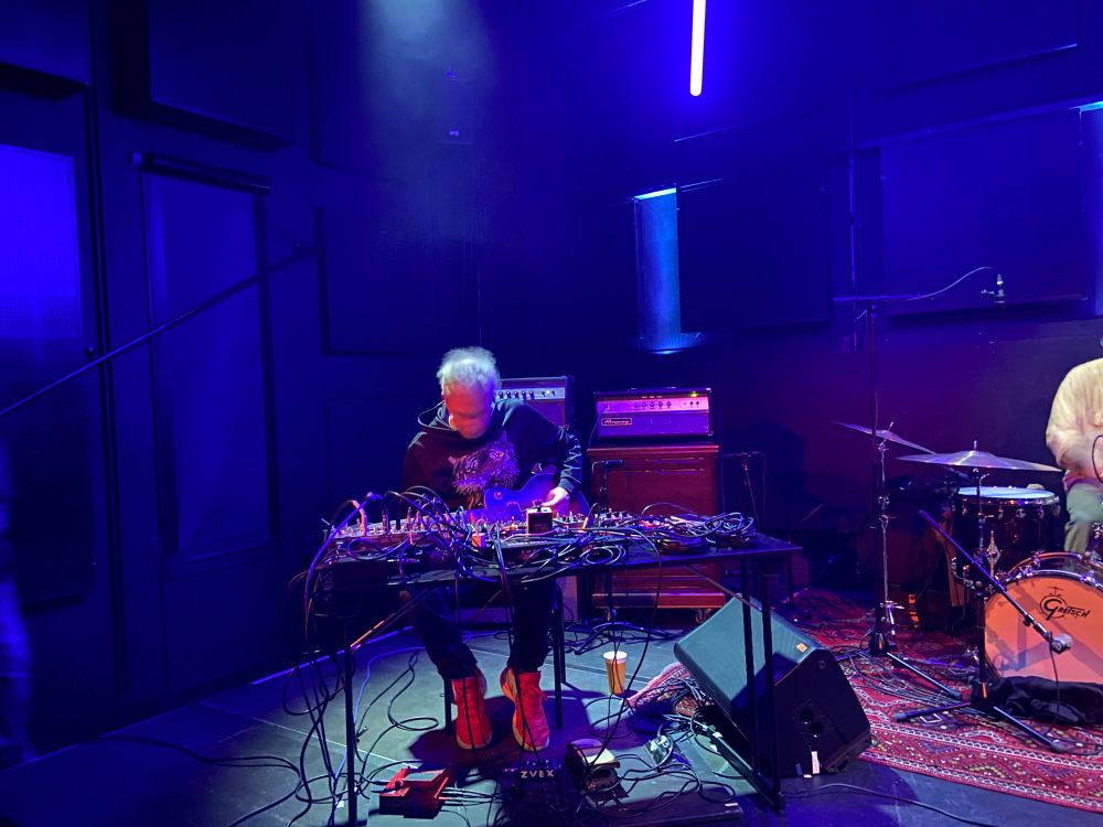 Artist with guitar and pedals